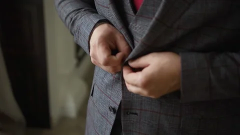 A man buttons on a stylish suit Stock Footage 167897905