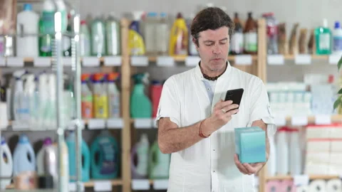 Man buyer scans qr code on panty liners label Stock Footage 310682350