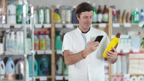Man buyer scans qr code on parquet polish agent Stock Footage 314244854