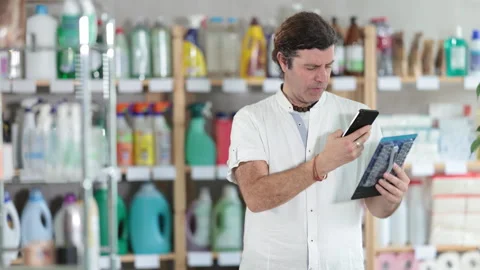 Man buyer scans qr code on razor label Stock Footage 327137271