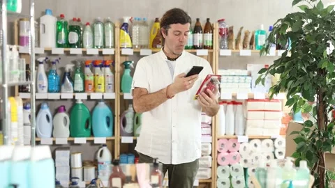 Man buyer scans qr code on razor label Stock Footage 342129360