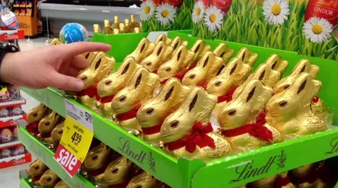 Man buying chocolate rabbit inside supermarket Stock Footage 48484789