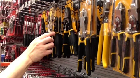 Man buying compound action diagonal pliers and adjustable wrench Video stock 53127608