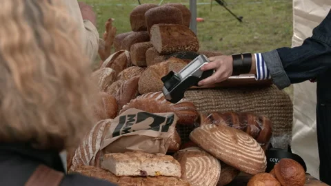 Man Buying Fresh Bread at a Charming Dutch Farmers Market Video stock 241597338