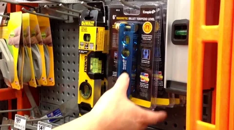 Man buying torpedo level Stock Footage 53177554