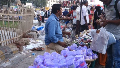 Man-buys-bangles-from-street-vendor-at-Charminar Stock Footage 99081194