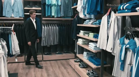 Man buys classic clothes and shoes in shop Stock Footage 66428094