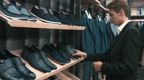 Man buys classic clothes and shoes in shop Stock Footage 66428108