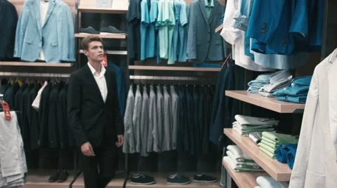 Man buys classic clothes and shoes in shop Stock Footage 66428131