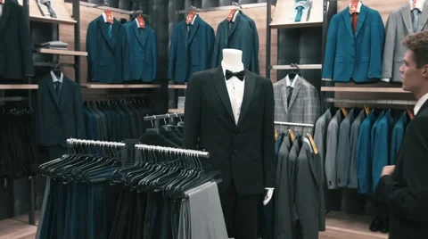 Man buys classic clothes and shoes in shop Stock Footage 66428155