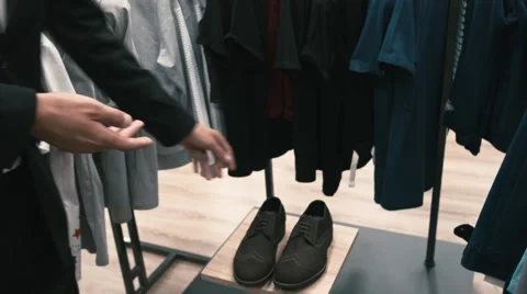 Man buys classic clothes and shoes in shop Stock Footage 66428167
