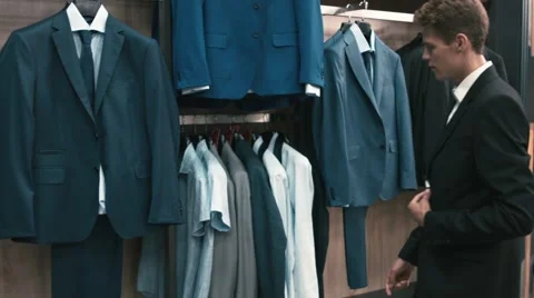 Man buys classic clothes and shoes in shop Stock Footage 66428171