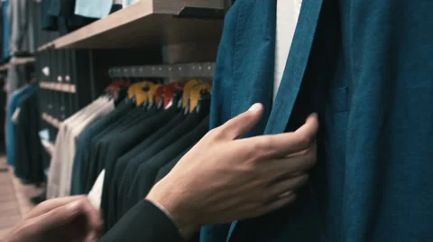 Man buys classic clothes and shoes in shop Stock Footage 66428178