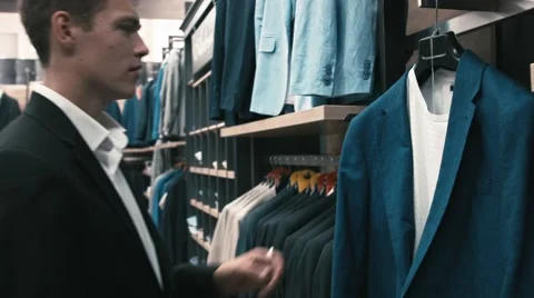 Man buys classic clothes and shoes in shop Video stock 66428200