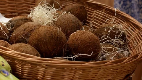 Man buys coconuts it the market. Hands holding the coconuts close up Stock Footage 112179816