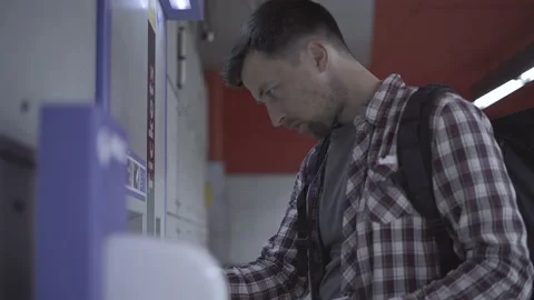 Man buys fare from vending machine in Munich, Germany. Male using ticket machine Stock Footage 220606384