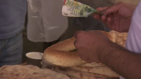 Man buys Jerusalem style bagel from street vendor Stock Footage 86759565
