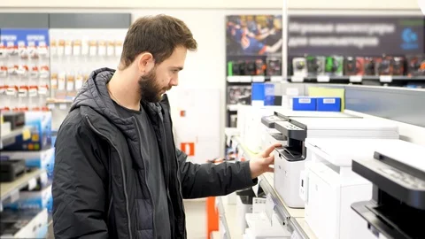 Man buys a printer in store. 4k UHD Stock Footage 85624701