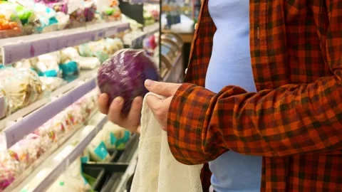 Man buys red cabbage in the vegetable section of a supermarket. While in the 動画素材 221411520