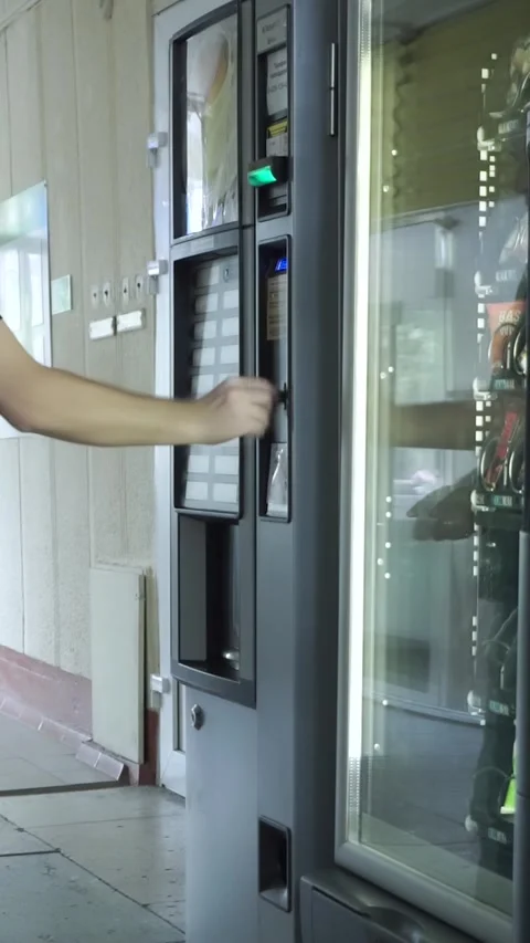 A man buys a snack or drink from a vending machine Stock Footage 286102710