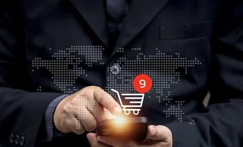 Man buys things online using his mobile phone or laptop. online transaction.. Stock Photos