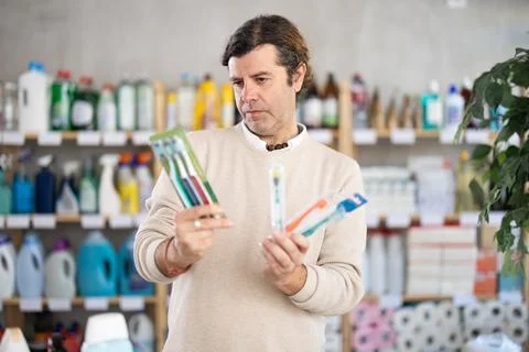 Man buys toothbrushes Stock Photos