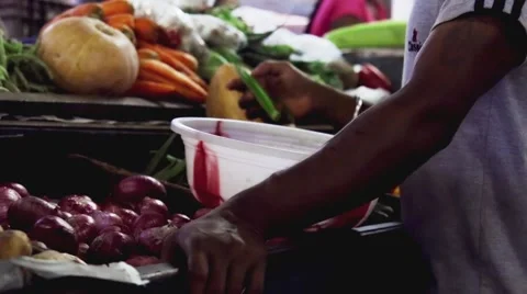 Man buys vegetables on indian local market Video stock 59798227