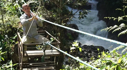 Man in Cable Car Over River Coming Stock Footage 54802101