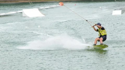 Man Cable Skiing and Wakeboarding at a Water Park in Singapore Stock-Footage 328493105