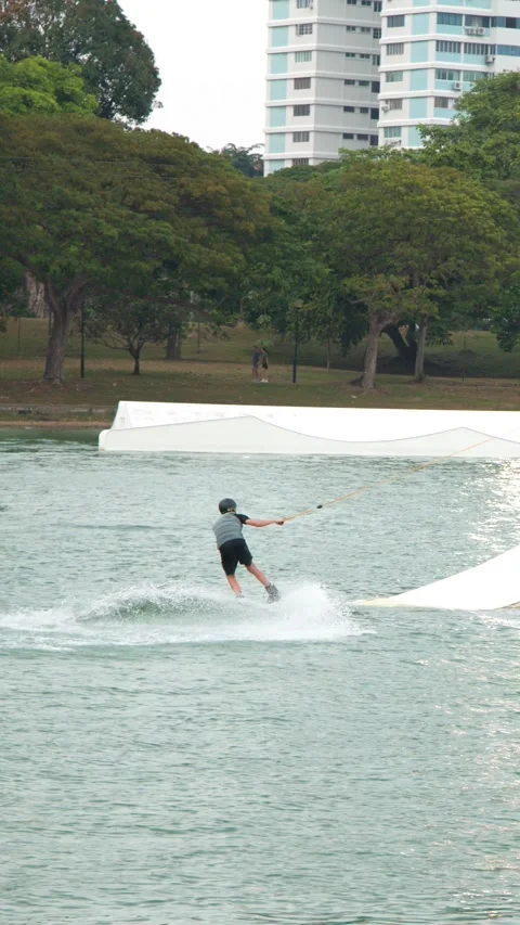 Man Cable Skiing and Wakeboarding at a Water Sports Park in Singapore Stock-Footage 328499061