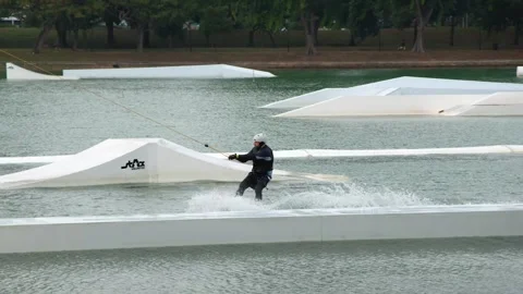 Man Cable Skiing and Wakeboarding at a Water Park in Singapore Stock-Footage 328560763