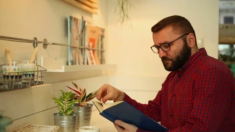 Man in the cafe and reading book and drink caffee, close Stock Footage 70859326