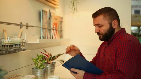 Man in the cafe and reading book, close Stock Footage 70859418