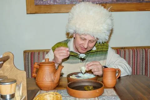 A man in a cafe eats a freshly prepared Caucasian dish. Stock Photos