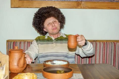 A man in a cafe eats a freshly prepared Caucasian dish Stock Photos