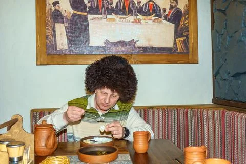 A man in a cafe eats a freshly prepared Caucasian dish Stock Photos