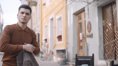 Man in a cafe gets up from his chair and picks up his coat Video stock 243826744