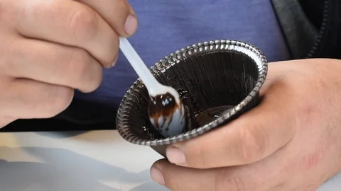 The man in the cafe has a muffin with chocolate filling Stock Footage 109620710