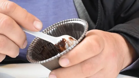 The man in the cafe has a muffin with chocolate filling Stock Footage 109620728