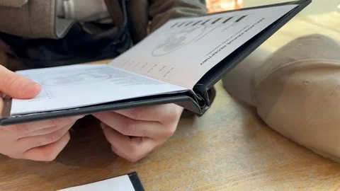 A man in a cafe looking through the menu Stock Footage 304609002