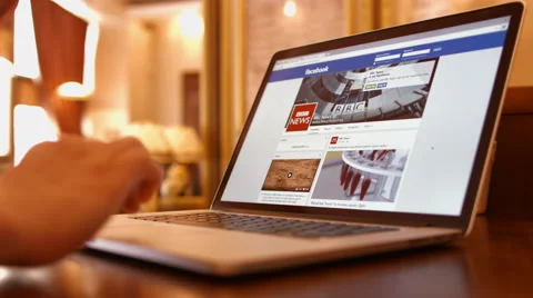Man in a cafe reading bbc news on Facebook Video stock 50207422