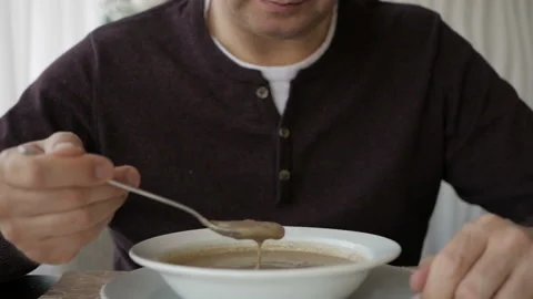 The man at the cafe table is slowly eating soup. Business lunch Video stock 105647642