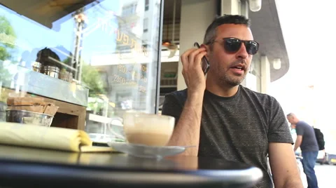 Man in a cafe talking on the phone Stock Footage 48455995