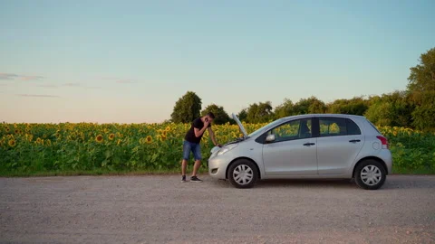 Man call for help by phone on road at car. Young adult male 30s person Stock Footage 157696204
