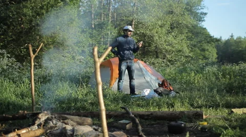 Man call by smartphone in camping Stock Footage 64057820