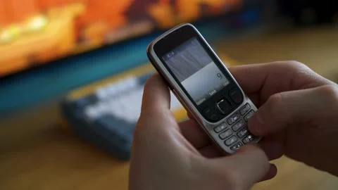 Man calling 911 from an outdated cell phone Stock Footage 157197678