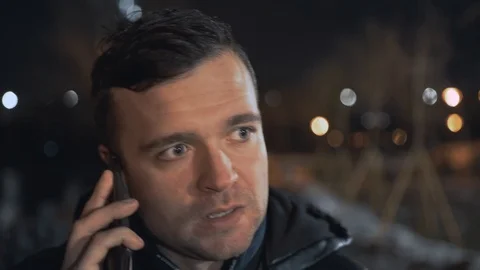 Man calling and talking on smart phone with mimic emotions smiling and sad at ni Stock Footage 102424493