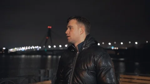 Man calling and talking on smart phone with mimic emotions smiling and sad at ni Stock Footage 102424809