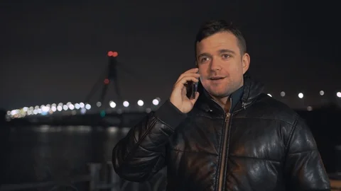 Man calling and talking on smart phone with mimic emotions smiling and sad at ni Stock Footage 102424984