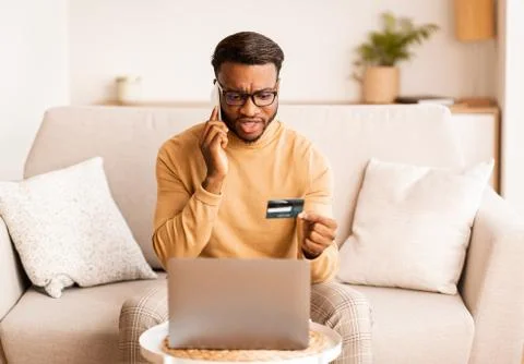 Man calling to bank solving problems with credit card indoor Stock Photos
